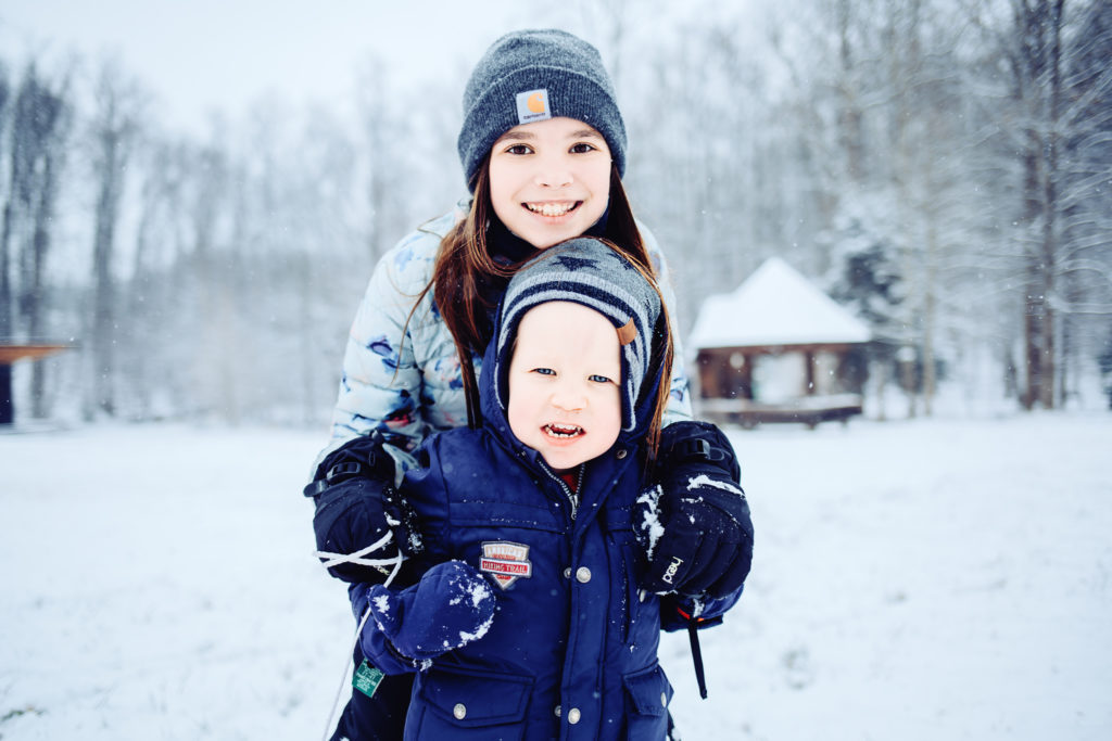 two kids smiling in the snow