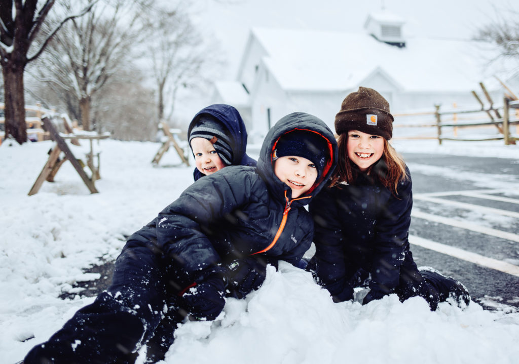 three kids in a snowpile at Wolf Trap Park
